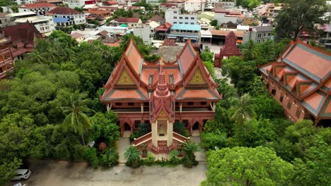 cambodian temple rooftops framed by lush green urban scenery