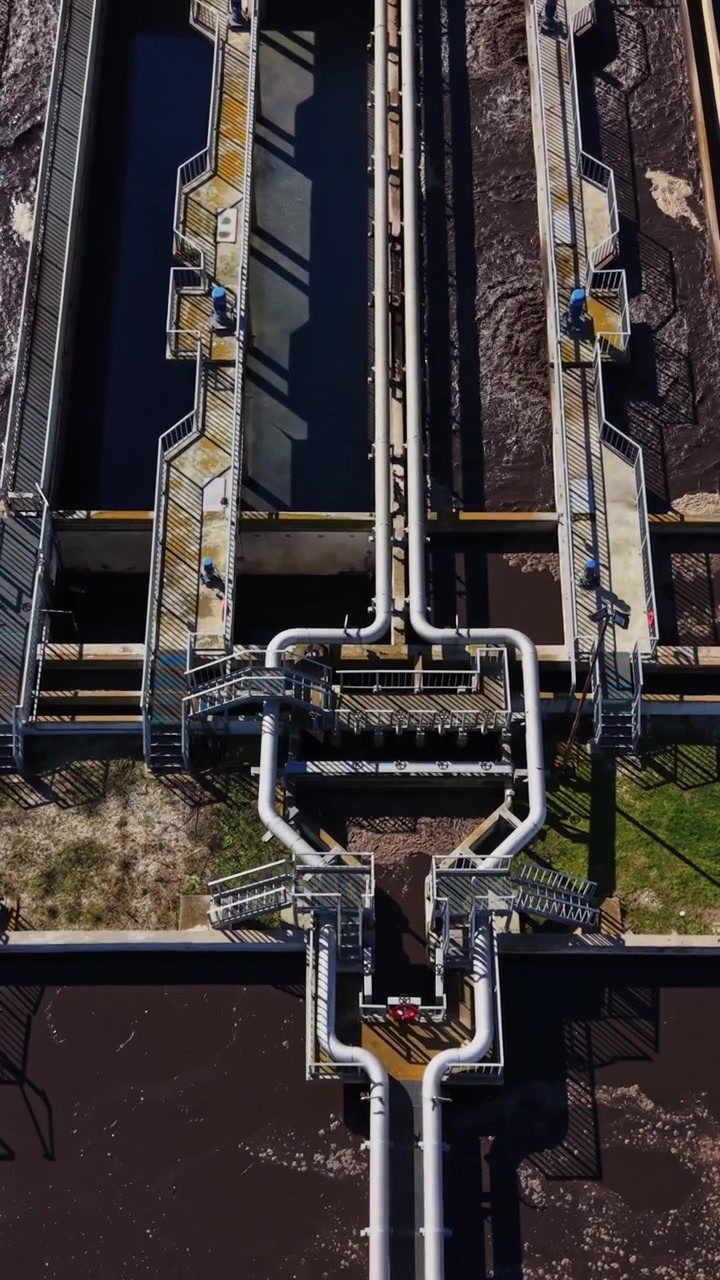 Water treatment facility shows tanks and pipes at work in the city