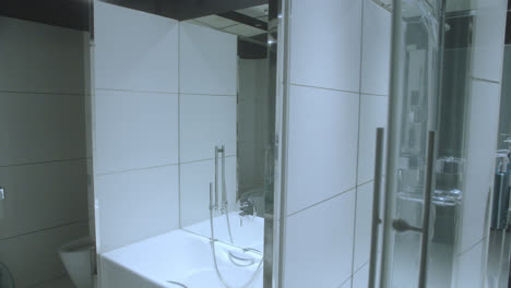 beautiful, slightly moving shot of the jacuzzi and shower of an elegant bathroom inside a 5-star luxury hotel room in spain.