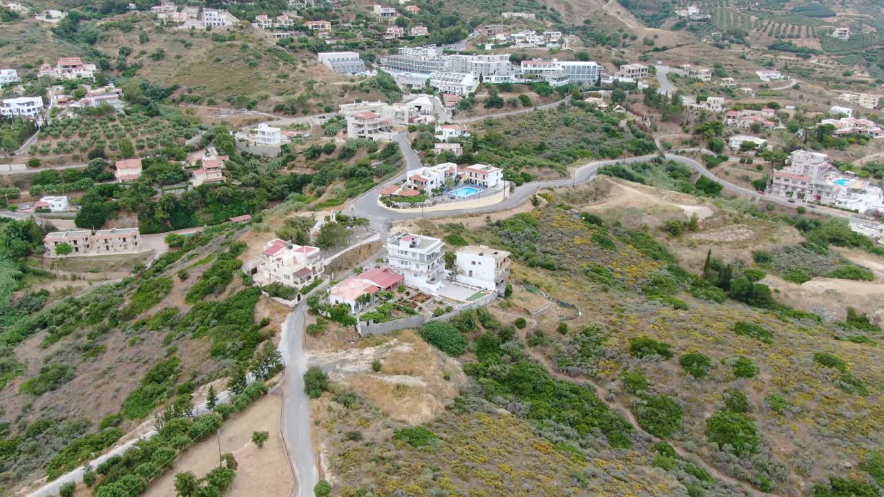 Aerial view of a beautiful residential area in the island of Crete. Tilt reveal