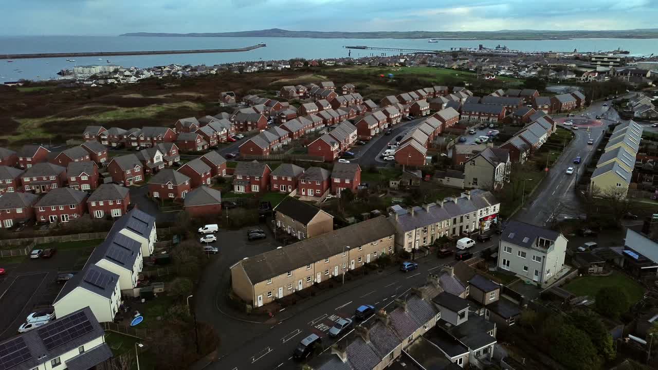 Island housing neighbourhood aerial view circling the town port of Holyhead, Anglesey, North Wales