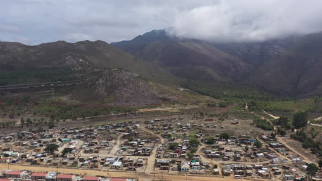 township along mountains in south africa aerial back traveling