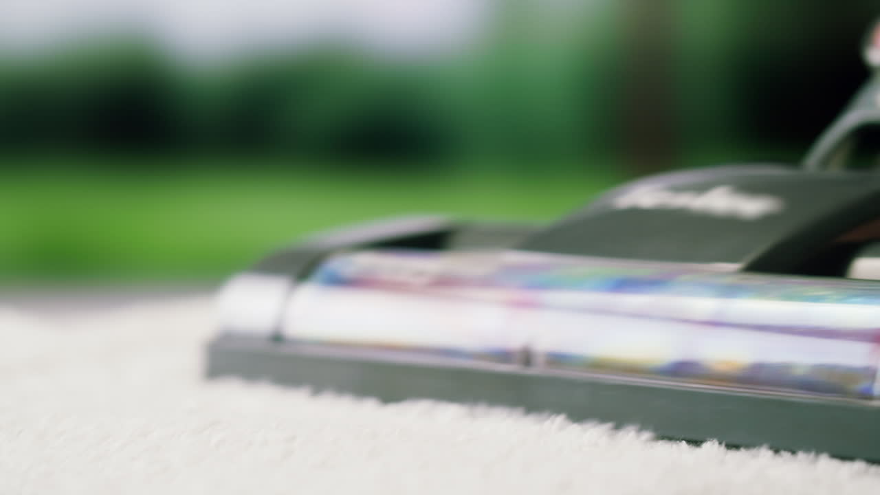 Close Up of Vacuum Cleaner Head Cleaning White Carpet