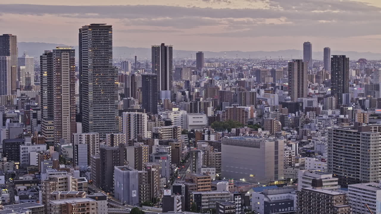 Osaka Japan Aerial v12 zoomed low flyover Oyodonaka capturing a densely populated downtown cityscape, with views of Fukushima and Kit wards at dusk - Shot with Mavic 3 Pro Cine - Oct 8th 2023