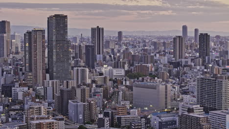 osaka japan aerial v12 zoomed low flyover oyodonaka capturing a densely populated downtown cityscape, with views of fukushima and kit wards at dusk - shot with mavic 3 pro cine - oct 8th 2023