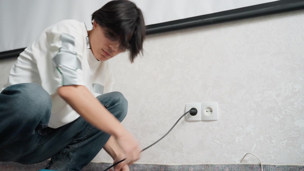 Testing vacuum power on carpet first. Ensuring vacuum operates correctly before full cleaning process starts. Man examines vacuum efficiency by testing suction and adjusting hose on carpeting