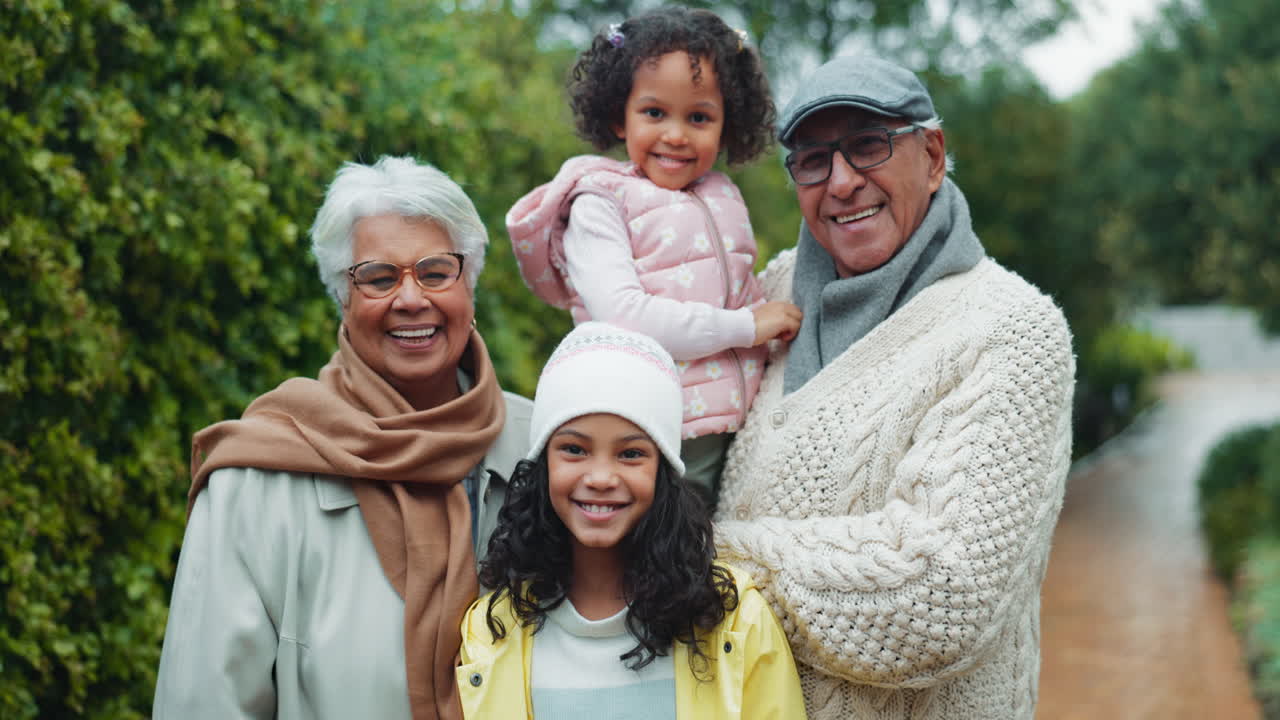 Happy family of grandparents and grandchildren smiling together on a rainy day