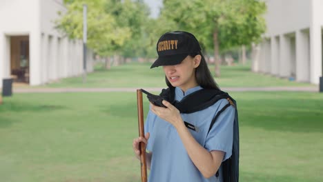 Angry-Indian-female-security-guard-shouting-on-someone-through-walkie-talkie