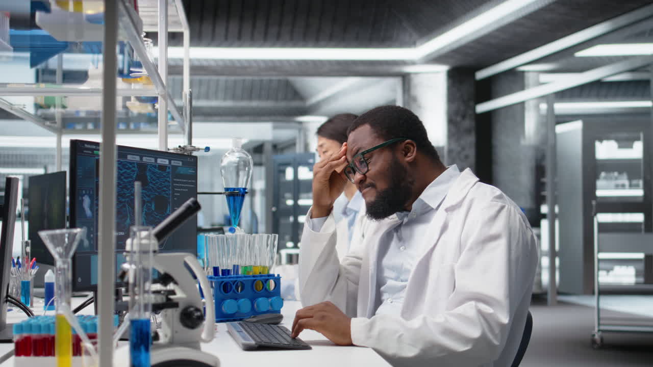 Vertical video Scientist uses computer for DNA data analysis in laboratory, doing brainstorming