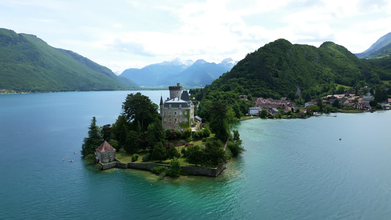 Parallax drone shot of Duingt Castle during the day with Lake Annecy in Haute-Savoie, France
