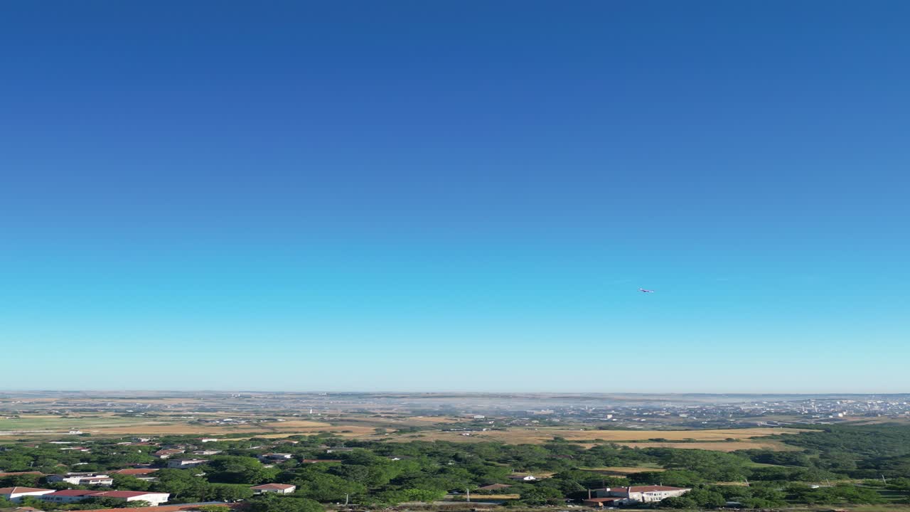Airplane and drone flying over the village