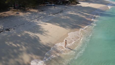 Happy-woman-enjoying-beautiful-life,alone-on-paradise-island-in-Indonesia-during-summer