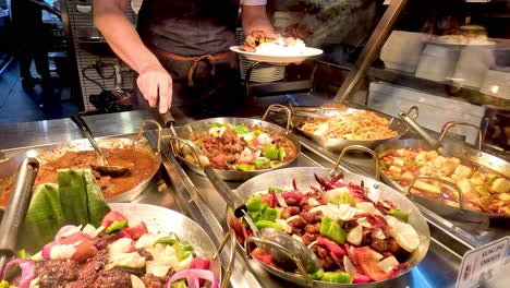 person serving malaysian food at market stall