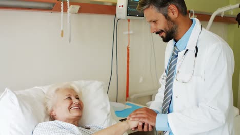 doctor consoling senior patient