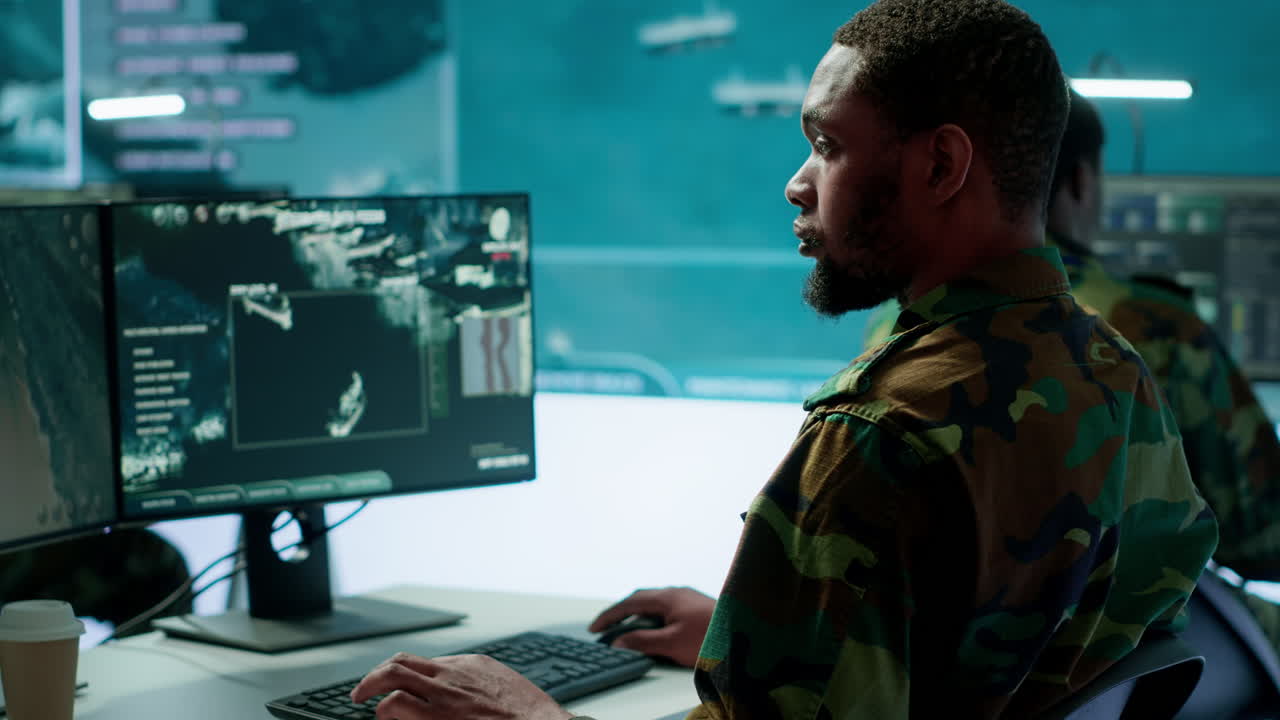 Team of military specialists oversee surveillance activity by using cctv footage