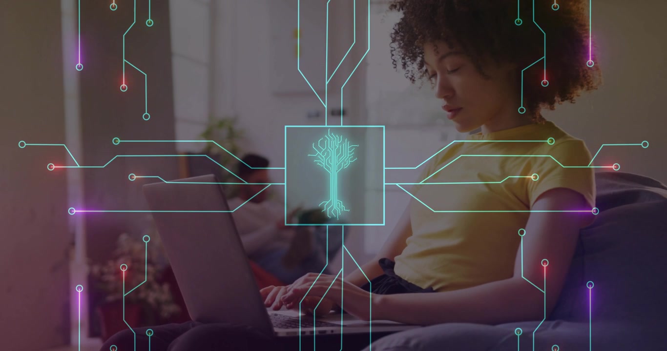 Woman typing on laptop and activating neon circuitry overlay then manipulating tech visualization