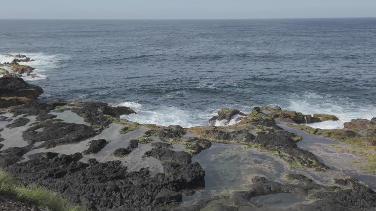 Rugged coastline of Mosteiros, Sao Miguel with waves crashing on volcanic rocks