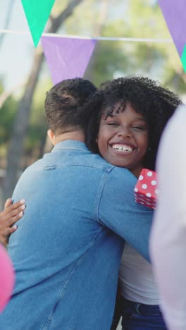 Joyful Hug and Gift Exchange at an Outdoor Party