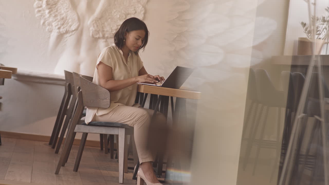 Female Freelancer in Modern Cafe