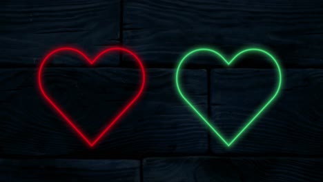 Animation-of-red-and-green-neon-hearts-flashing-on-a-black-background