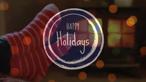 animation of happy holidays text over christmas socks
