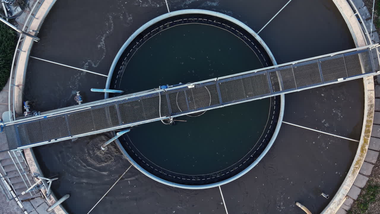 Water treatment facility uses large equipment for processing waste water at a plant in the early morning sunlight