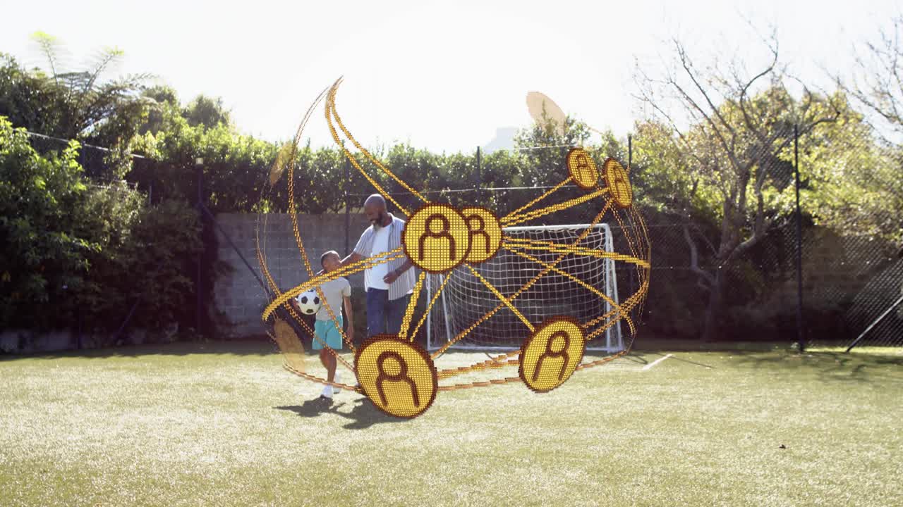 Dad and boy entering, causing gold network orbiting in front, with soccer ball, practicing sports