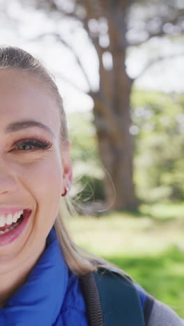 vertical video of portrait of happy caucasian woman in park, slow motion