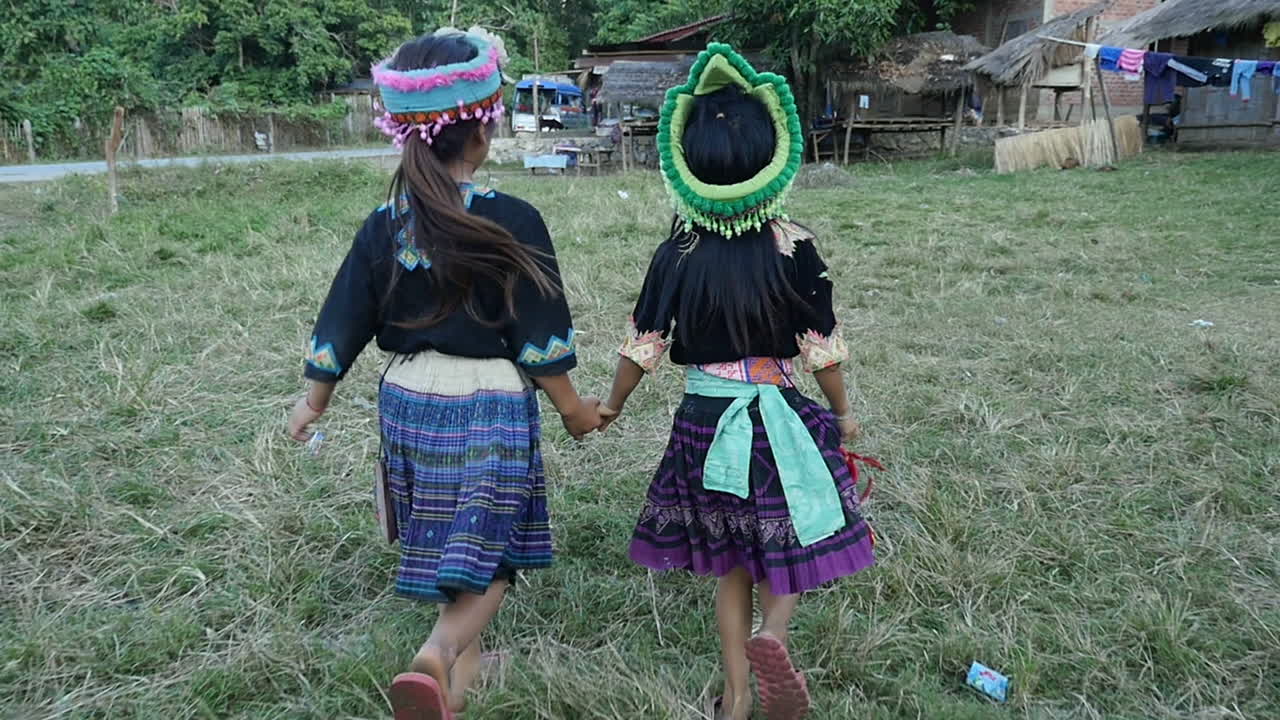Two Girls in Traditional Attire Walking Together