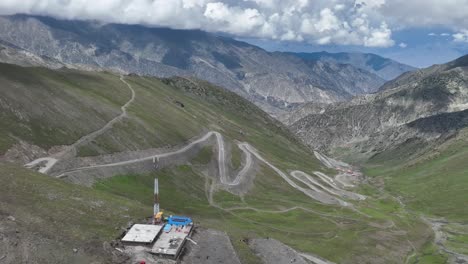 a drone retreats upwards over babusar pass, revealing the sweeping vistas and rugged terrain of this stunning mountain pass in northern pakistan