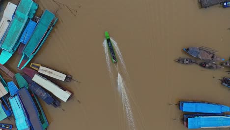 colourful boats over the calm mekong river in kompong khleang cambodia - aerial shot