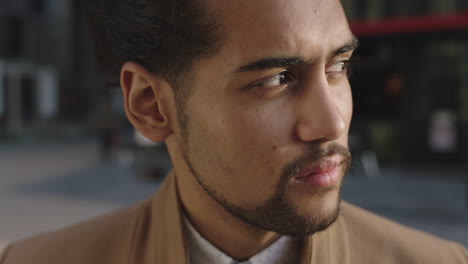 close-up-portrait-of-young-mixed-race-businessman-looking-confident-at-camera-turns-head-serious-pensive