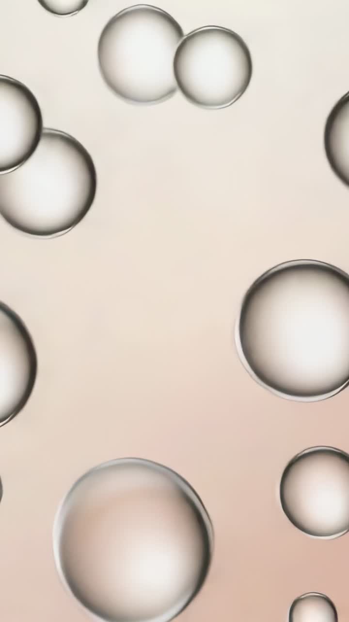 Video vertical: Bucle inicial de burbujas translúcidas flotando sobre un gradiente vertical, creando un fondo de pantalla.