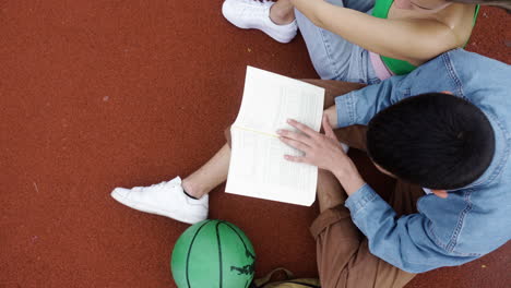 top view of students sitting on running track