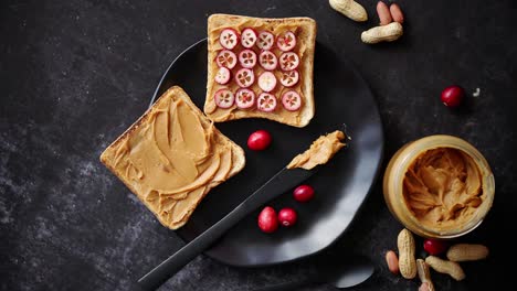 toasts bread with homemade peanut butter served with fresh slices of cranberries
