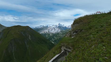 Flying-toward-majestic-snowy-Swiss-Alps-mountain-range-in-summer-season