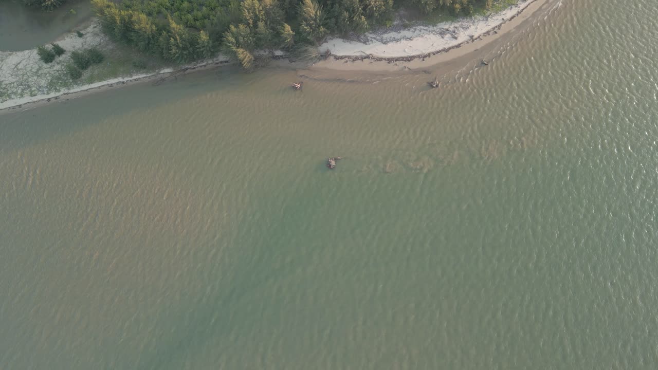 Aerial Drone View During Summer Gerigat Fishing Village,Kabong With, Facing Open Blue Sea, White Sandy Beach,Green Coconut, Palm Trees,And River,Sarawak,Borneo