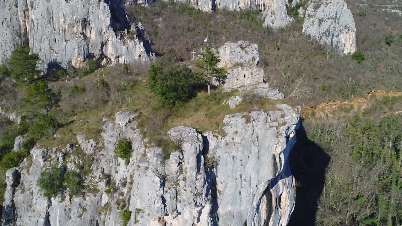 Wooden crosses on top of mountain, Christianity. Huge cliff. Aerial, Motovun