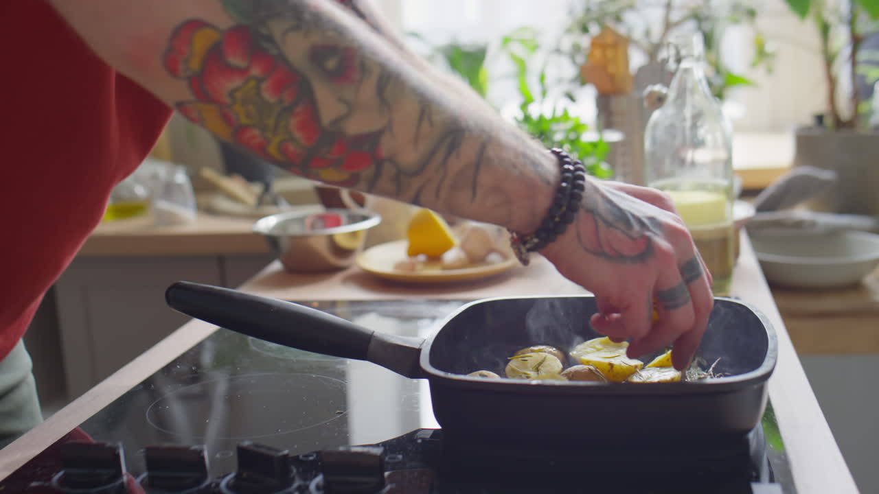 Man Frying Potato in Grill Pan