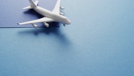 close up of white airplane model and copy space on blue background