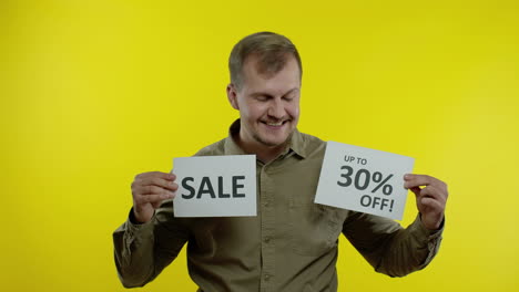 attractive man showing sale word and showing up to 30 percent off inscription. black friday concept