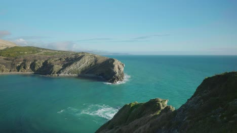toma de paisaje cinematográfico de 4k de la playa de lulworth cove, dorset en un día soleado