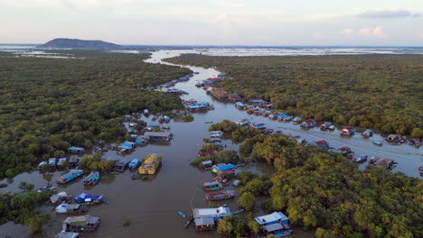 drone descends over cambodian river village