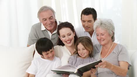 family reading a book in livingroom