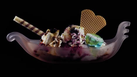 an ice cream cup looking like a ship, with different fruits