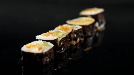 maki sushi roll served on black stone plate