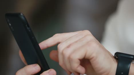 men hands close-up scrolling the tape of a smartphone