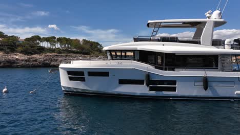 luxury yacht in calm bay on a sunny day filmed by drone in slow motion