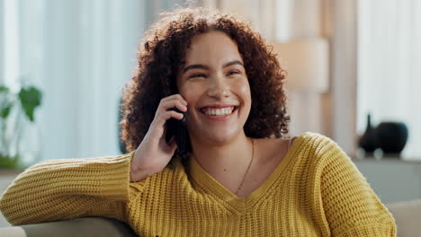 woman smiling while talking on her phone