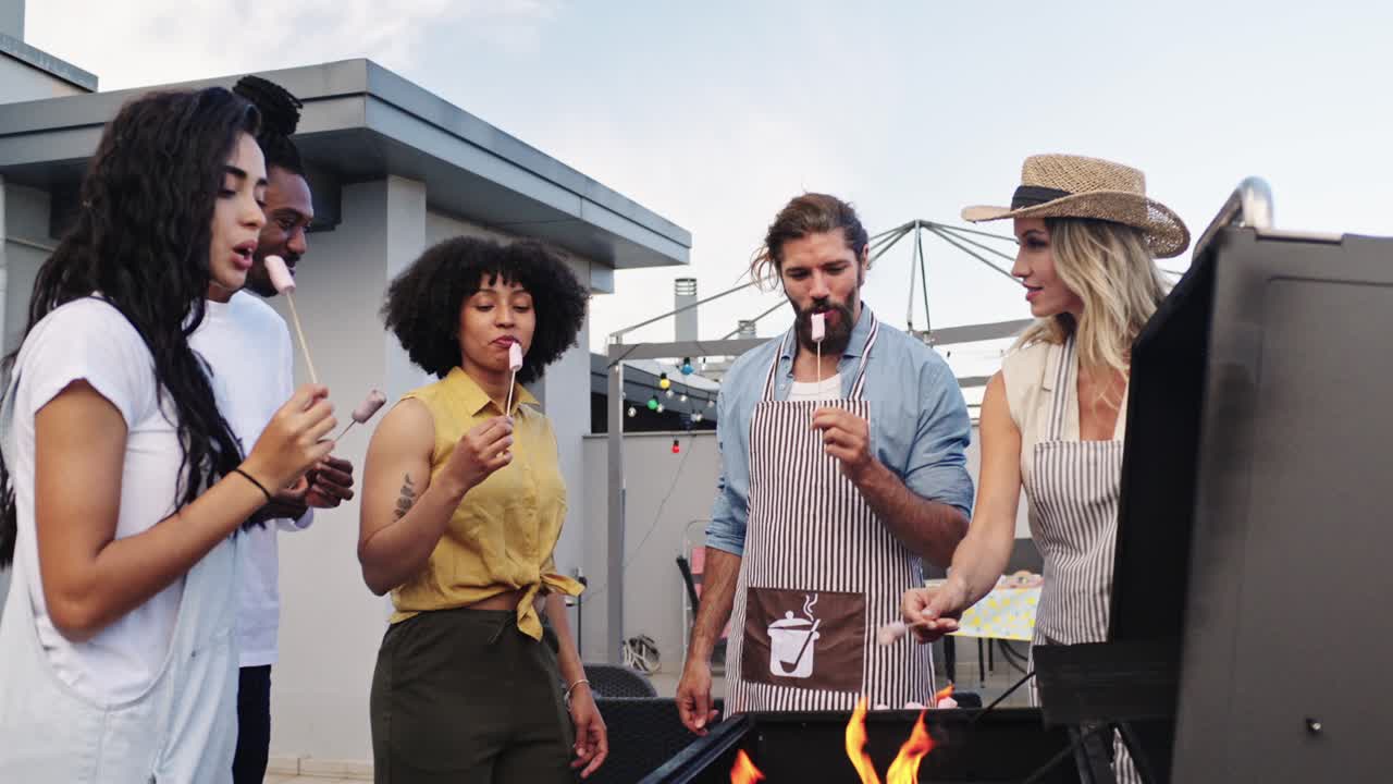 Friends roasting marshmallows on a grill